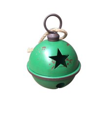 Green metal Christmas ornament with star design, round shape, and hanging loop.