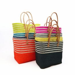 Handmade natural fiber beach bag in various colors and sizes. Striped pattern with leather handles.