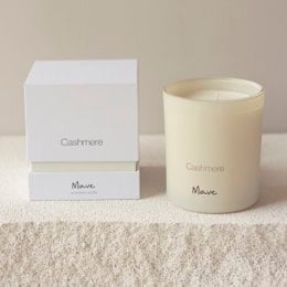 Cashmere-scented candle in a round, tall glass container with a white label and box.