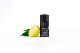 Natural deodorant with citrus and tea tree scent, in a black cylindrical container.