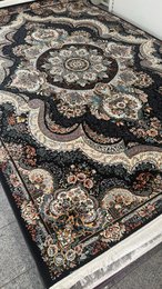 Large dark blue area rug with intricate floral and geometric patterns, suitable for living rooms or bedrooms.