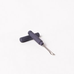 Mauve-colored, zero plastic earpick with a slim, cylindrical shape.
