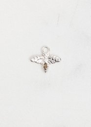 Silver charm with intricate floral design, suitable for jewelry or accessory.