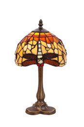 Tiffany-style table lamp with amber-colored glass shade featuring a dragonfly design, on a bronze-colored metal base.