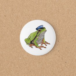Green frog illustration magnet, round white ceramic, decorative amphibian design.