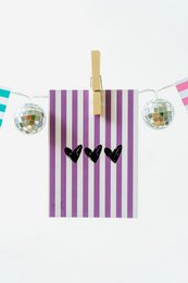 Colorful striped card with heart-shaped design, perfect for celebrations and greetings.