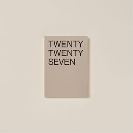 A dark brown journal with the text "TWENTY TWENTY SIX" embossed on the cover.
