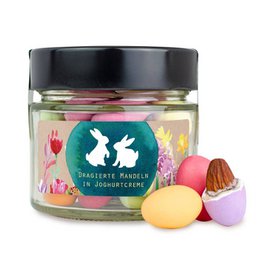 Colorful glass jar containing Easter-themed almond eggs. The jar has a screw-top lid and features decorative Easter bunny silhouettes.