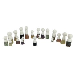 A set of 20 game pieces in various shapes and colors, including round, cylindrical, and irregular shapes in shades of white, brown, and black.