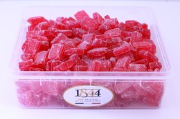 Square-shaped, vibrant red candies in a clear plastic container. The candies appear to be gummy or jelly-based, with a glossy, textured surface. The product is labeled as "Square Poppy Candies - 1kg" and is categorized as "Bonbons".