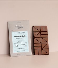 A 50% milk chocolate bar from the Madagascar region, with a simple and minimalist packaging design featuring the brand name and product details.