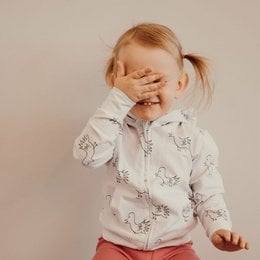 Soft, cozy hoodie with a doll-like bird print in white and milky green colors, available in sizes 6-12 months to 3 years.