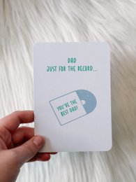  This Father's Day card features a simple, minimalist design with the text "Dad, you're the record" and a vinyl record icon. The card's design and message convey a heartfelt sentiment for a father figure.