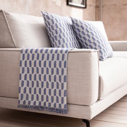 A large, soft, and cozy throw blanket in a marine blue color with a geometric pattern. Available in multiple sizes to fit a variety of spaces.