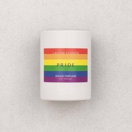 Scented candle with a rainbow-colored label, featuring a round, white candle in a glass container.