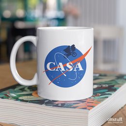 White ceramic mug with "CASA" logo and NASA-inspired design. Suitable for hot and cold beverages.