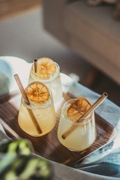 10 Swedish reed straws, cocktail accessories, yellow citrus slices, wooden tray
The image shows 2 cocktail glasses filled with a yellow liquid, likely a citrus-based cocktail. The glasses are garnished with slices of yellow citrus fruit, possibly lemon or orange. The cocktail is served on a wooden tray, along with a green leaf, likely from a tropical plant. The description captures the key visual elements of the product, including the materials (Swedish reed straws), the category (cocktail accessories), and the specific details of the cocktail presentation (yellow citrus slices, wooden tray).