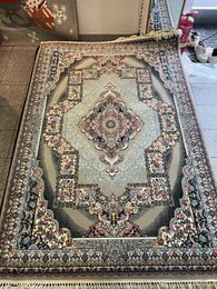 Large dark blue area rug with intricate floral and geometric patterns, suitable for living rooms or bedrooms.