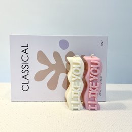  Tall, cylindrical pillar candle in a variety of neutral and pastel colors including cream, beige, brown, dark brown, taupe, pastel green, aquamarine, baby blue, pink, lilac, yellow, and orange.