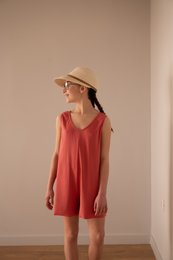 A red sleeveless jumpsuit for kids, suitable for ages 4-12. The jumpsuit features a relaxed, casual style with a wide leg and a V-neckline.