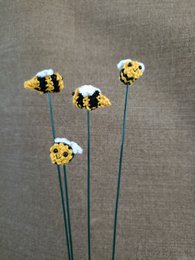  Cute crocheted bee on a stick, artificial plant decoration in orange and black colors.
