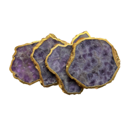 Amethyst gemstone coaster with golden trim, a decorative and functional gift item made of natural crystal.