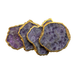 Amethyst gemstone coaster with golden trim, a decorative and functional gift item made of natural crystal.