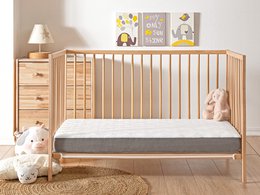 Airy, lightweight baby mattress in natural wood tones, suitable for crib or toddler bed, with soft, breathable fabric cover.
