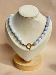 Blue and white beaded necklace with gold clasp, chunky pearl-like beads, elegant jewelry accessory.