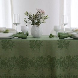 Green linen tablecloth with floral pattern, suitable for formal or casual dining. Includes plates, glassware, and decorative elements in complementary colors.