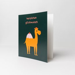 Greeting card with a dromedary (camel) illustration and the text "Herzlichen Glückwunsch" (Congratulations) in German. The card is green in color and the camel is orange. The product is available in various pack sizes.