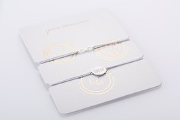 Delicate silver-tone friendship bracelets with a simple, elegant design. Features a clasp closure for easy wear.