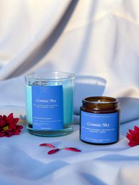  Cosmic Sky scented candles in small and large sizes, with a blue-colored wax and a floral scent.