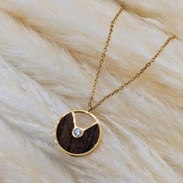 Gold and rose gold necklace with a round pendant featuring a diamond accent.