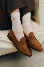 Brown suede loafers, cream ribbed socks, casual footwear, comfortable slip-on shoes.