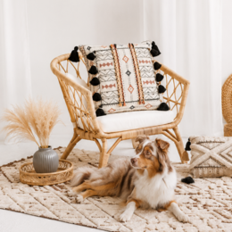 The pillowcase features a geometric pattern with black tassels, a mix of colors including white, red, and black, and a textured woven design. The overall style is bohemian and decorative, suitable for use as a cushion cover.