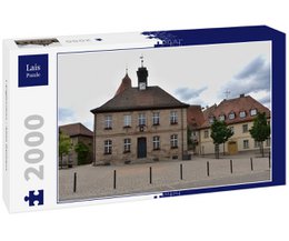A 2000-piece puzzle depicting the historic old town hall in Langenzenn, Germany. The image shows a traditional German building with a distinctive roof and architecture, surrounded by a cobblestone street and other buildings.