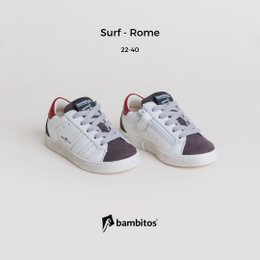Casual sneakers with a zipper on the inside, featuring a white and burgundy color scheme. The sneakers have a rounded, low-profile shape suitable for kids' sports activities.