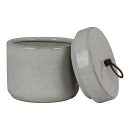 A round, tall grey ceramic storage jar with a lid and leather strap handle. The jar has a simple, minimalist design suitable for storing various household items.