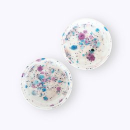  Set of 4 round coasters with colorful speckled patterns, suitable for use under cups or glasses.