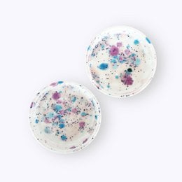 Set of 4 round coasters with colorful speckled patterns, suitable for use under cups or glasses.
