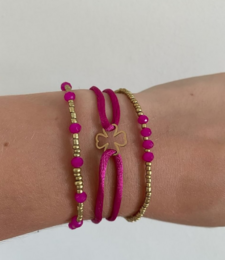 Satin cord bracelets in brown, beige, and green colors. The bracelets feature a simple, minimalist design with metal accents.