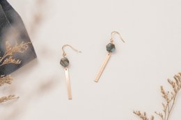 Elegant drop earrings with black beads and gold-toned accents.