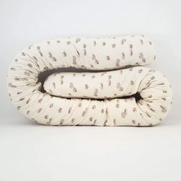 Decorative pillow with a print of small stone pine snakes or hedgehogs, suitable for a child's room.