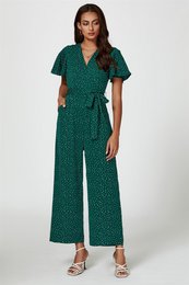 A green polka dot wrap jumpsuit with short sleeves and a v-neckline. The jumpsuit has a cinched waist and wide leg pants.