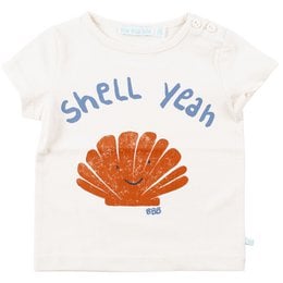 A white t-shirt with an orange seashell graphic and the text "Shell Yeah" printed on it. The t-shirt is part of a kids' clothing collection.