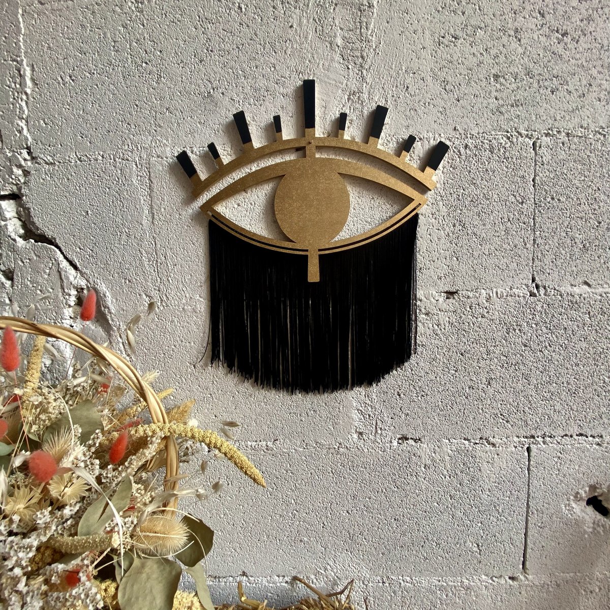 Occhio decorativo in legno e filo di cotone