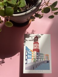Postcard featuring the iconic Domtoren tower in a colorful cityscape. The image showcases the distinctive architecture and vibrant colors of the historic Dutch landmark.