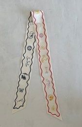 Silk scarf with abstract wavy pattern in shades of gray, pink, and white.