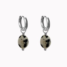 Silver hoop earrings with dalmatian stone pendants. Elegant and stylish accessory featuring a unique spotted pattern.